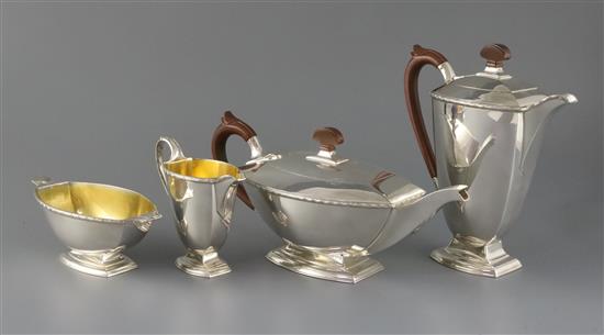 A George VI Art Deco silver four piece pedestal tea set by Adie Brothers, gross 55 oz.